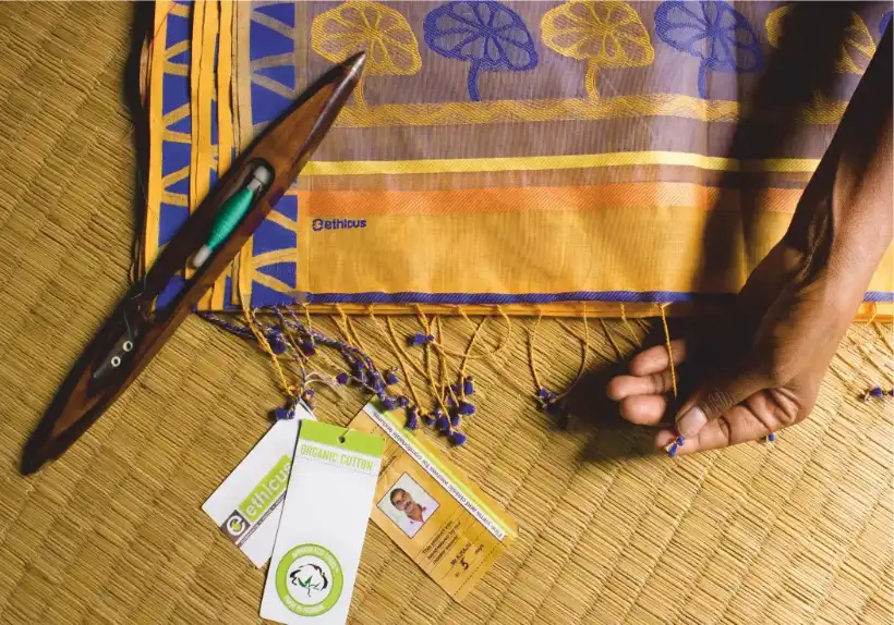 A shuttle and Ethicus labels on a handloom